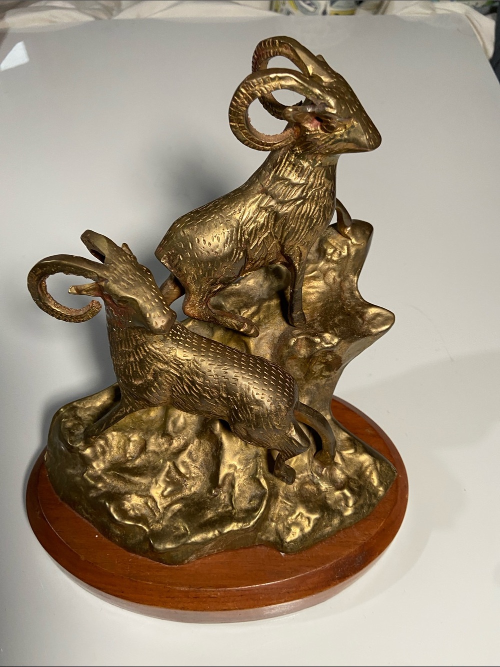 Vintage brass statue from the 1970s features two bighorn rams.